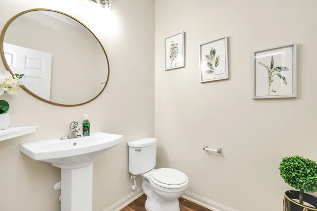a bathroom with a toilet a sink and a mirror