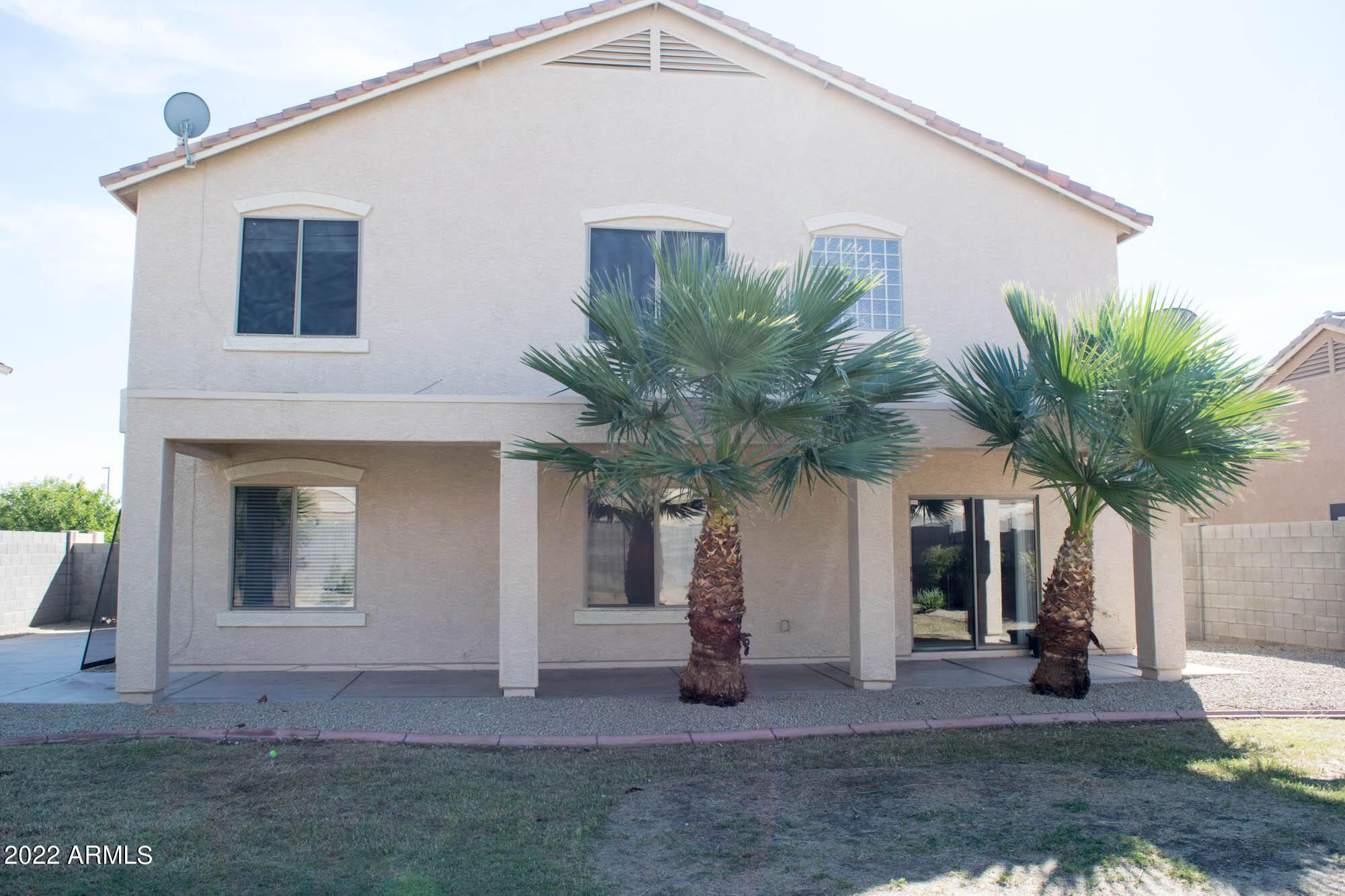 430 South 166th Avenue Goodyear, AZ 85338 - Photo 12 of 17 a view of a house with a yard and potted plants
