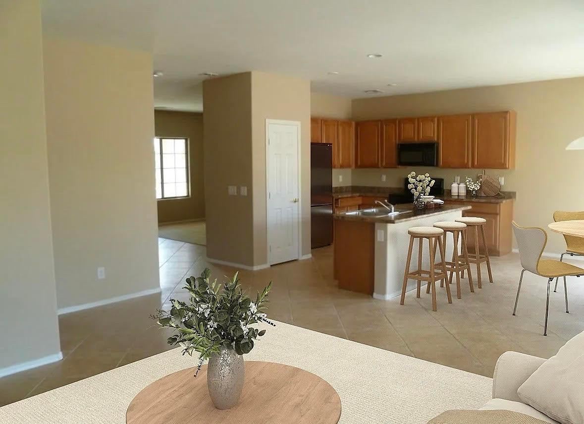 430 South 166th Avenue Goodyear, AZ 85338 - Photo 3 of 17 a kitchen with stainless steel appliances kitchen island granite countertop a refrigerator a stove a sink dishwasher and white cabinets with wooden floor