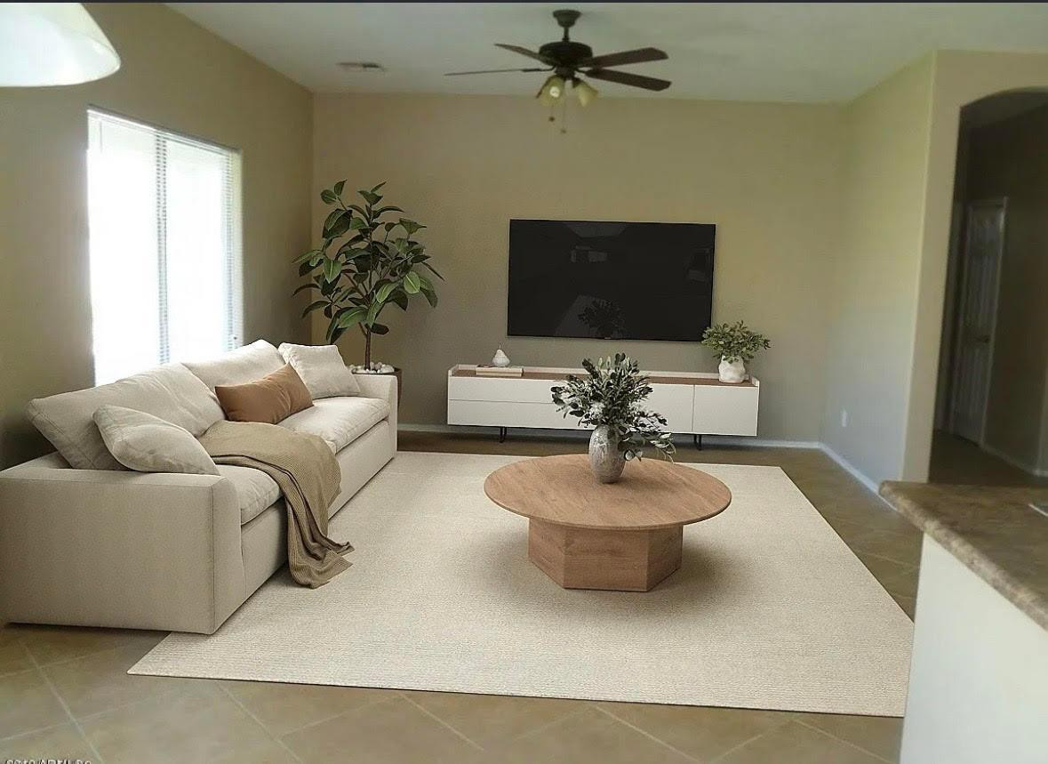 430 South 166th Avenue Goodyear, AZ 85338 - Photo 4 of 17 a living room with furniture and a flat screen tv