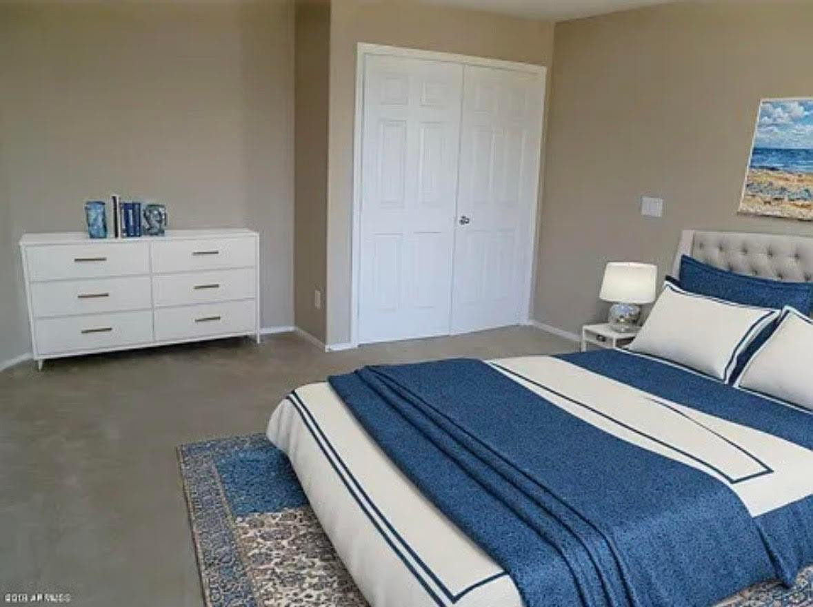 430 South 166th Avenue Goodyear, AZ 85338 - Photo 8 of 17 a bed room with a bed and a couch