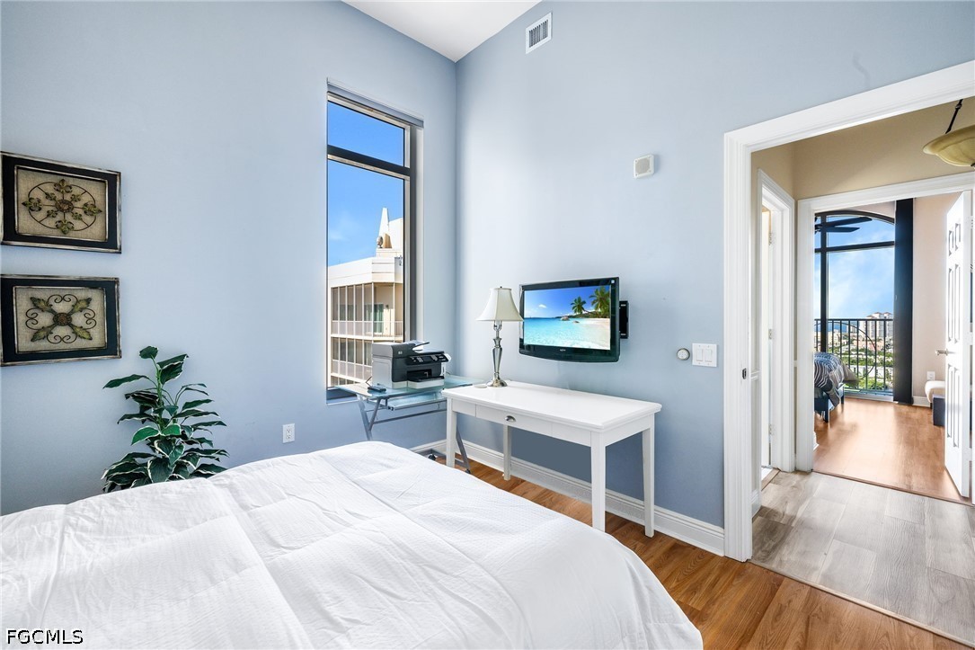 2745 First Street, Unit 2703 Fort Myers, FL 33916 - Photo 6 of 34 a bedroom with a bed and a flat screen tv