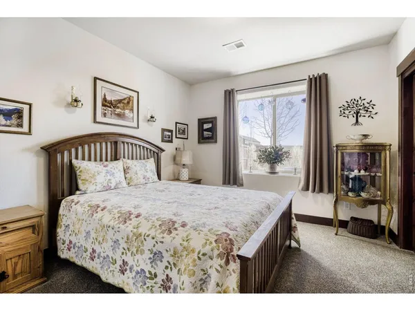 a bedroom with a bed and dresser with mirror
