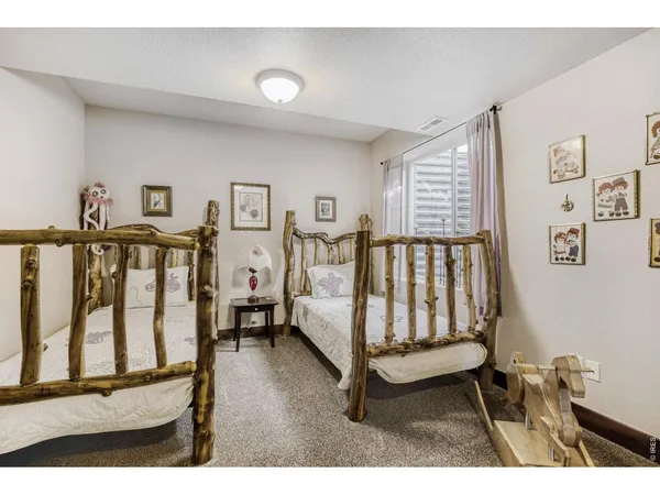 a bedroom with furniture and a window