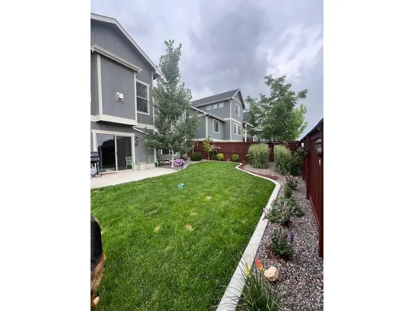 a backyard of a house with table and chairs