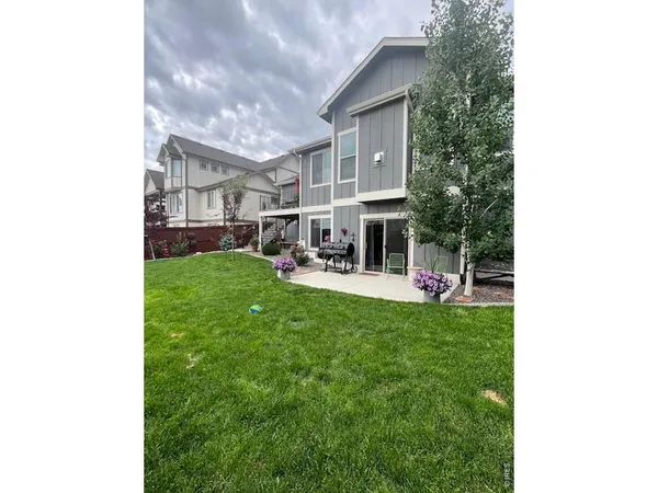 a view of a house with a backyard porch and sitting area