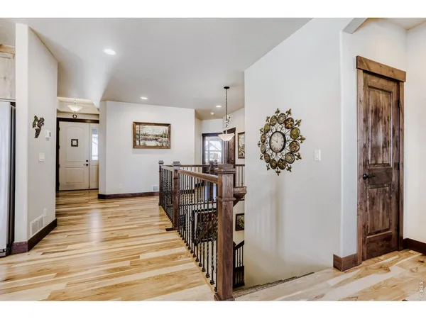 a view of a hallway with a livingroom and dining room