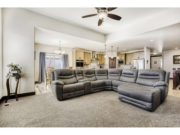 a living room with furniture and a chandelier
