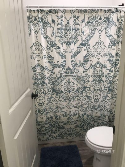 124 Rancho Del Cerro Ridgecrest, CA 93555 - Photo 14 of 21 a bathroom with a toilet and a shower curtain
