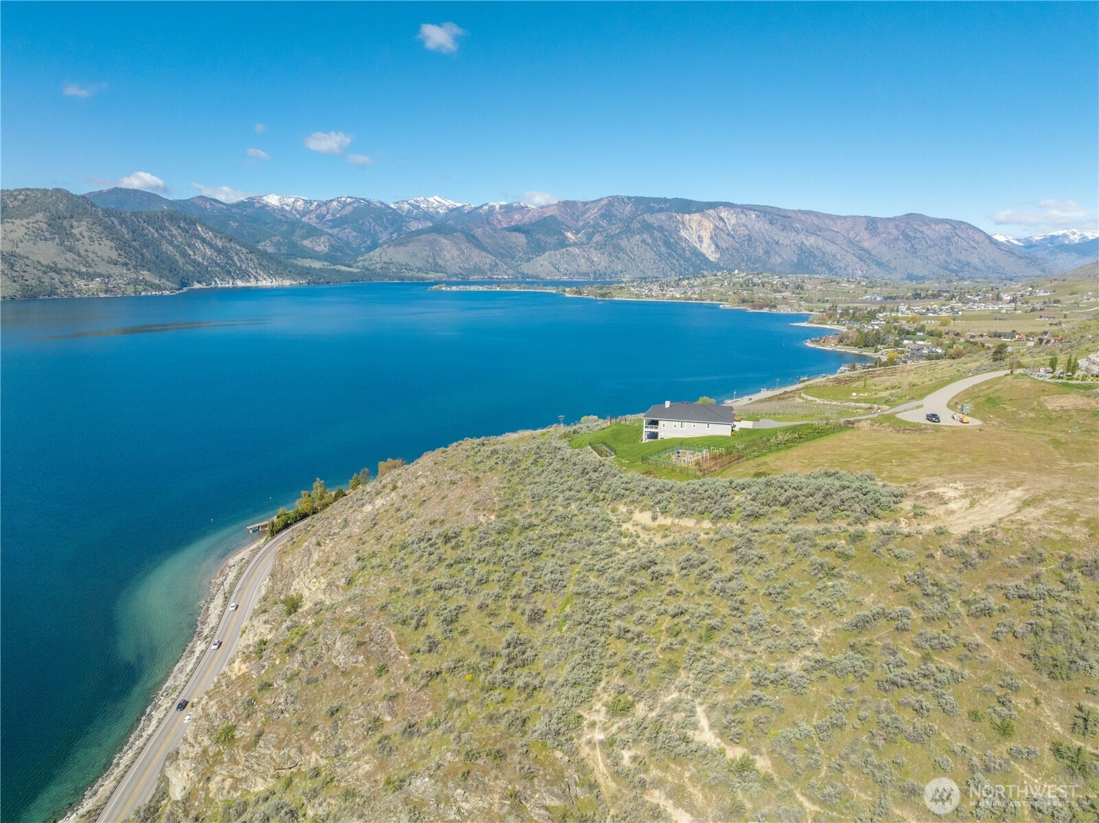 0 Rocky Point Lane Manson, WA 98831 - Photo 15 of 20 a view of a lake with mountains in the background