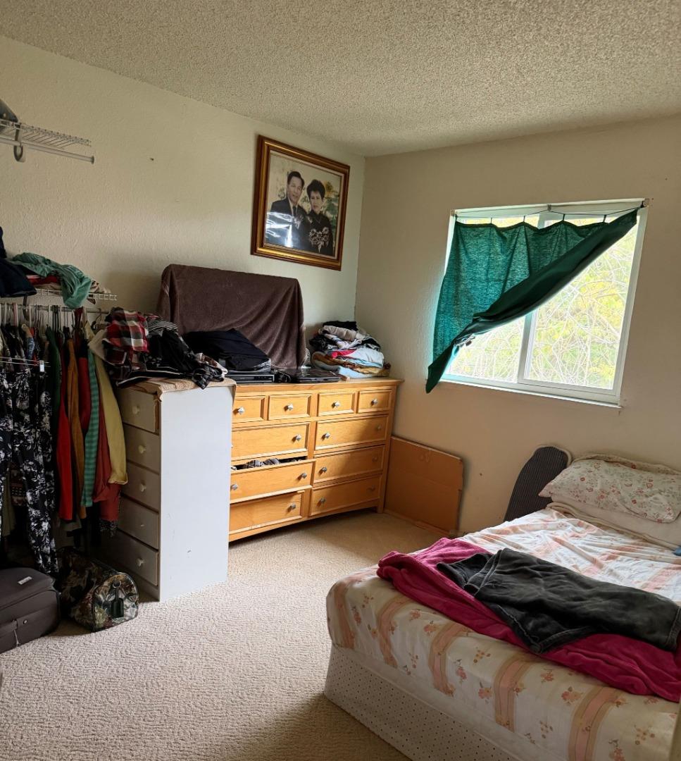 5957 Mack Road Sacramento, CA 95823 - Photo 5 of 9 a bedroom with a bed and a painting on the wall