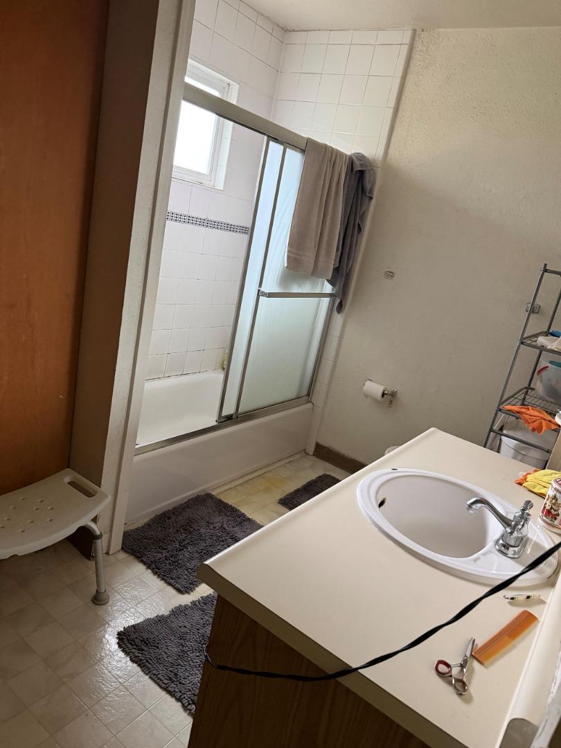 5957 Mack Road Sacramento, CA 95823 - Photo 7 of 9 a bathroom with a sink and a mirror