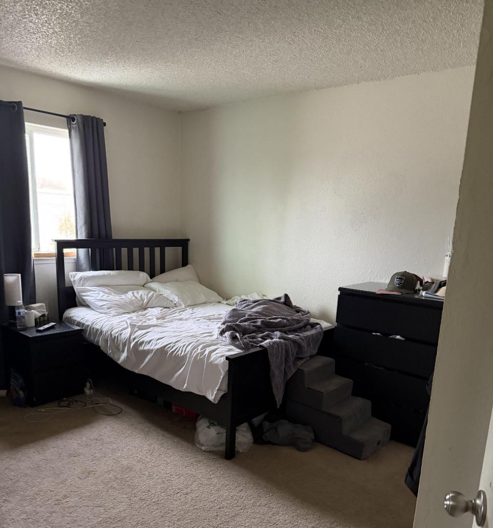 5957 Mack Road Sacramento, CA 95823 - Photo 8 of 9 a bedroom with a bed and window