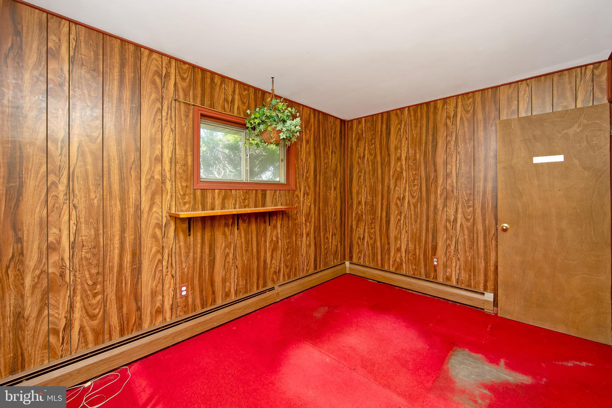 12 Geranium Road Levittown, PA 19057 - Photo 12 of 38 a view of a pool with red walls