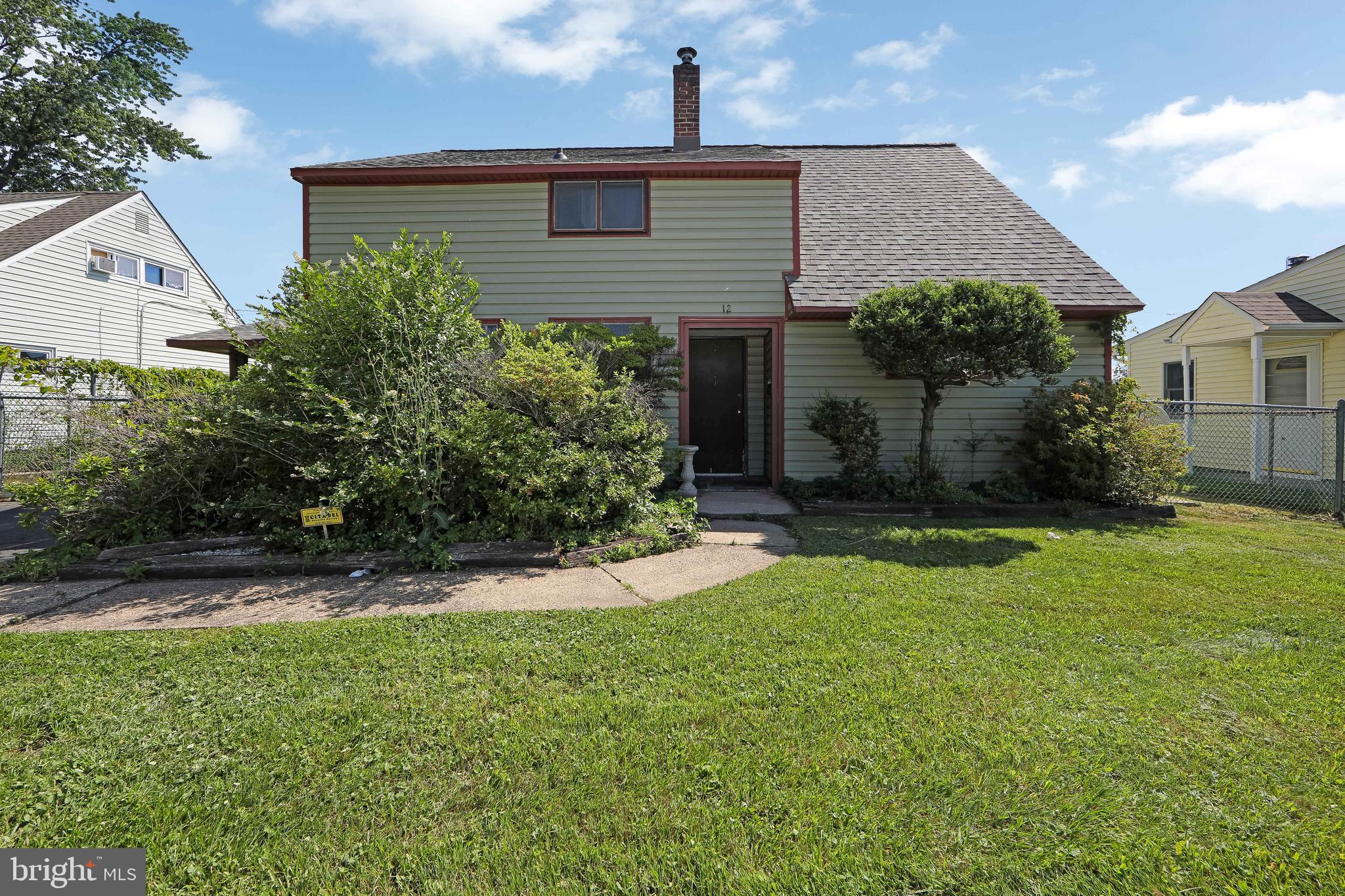12 Geranium Road Levittown, PA 19057 - Photo 2 of 38 a front view of a house with garden