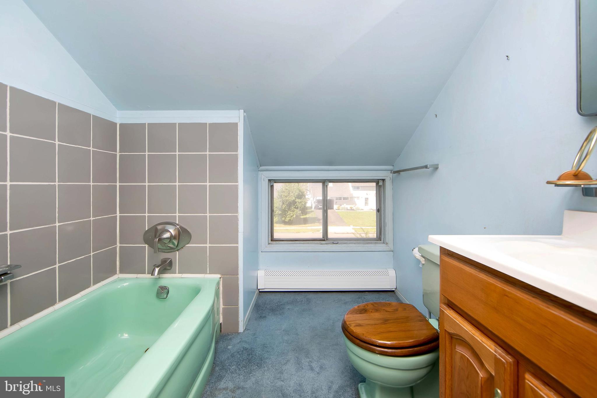 12 Geranium Road Levittown, PA 19057 - Photo 29 of 38 a bathroom with a sink a bathtub and a window