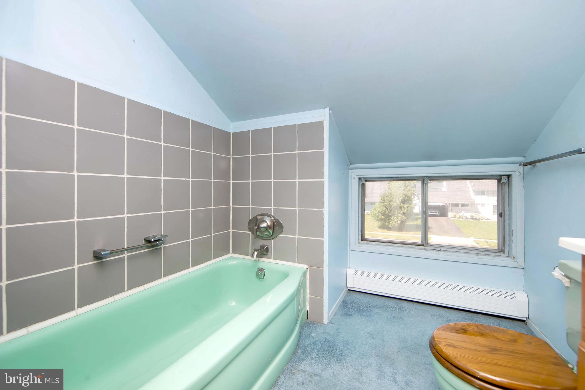 12 Geranium Road Levittown, PA 19057 - Photo 30 of 38 a bathroom with a tub a sink and a window