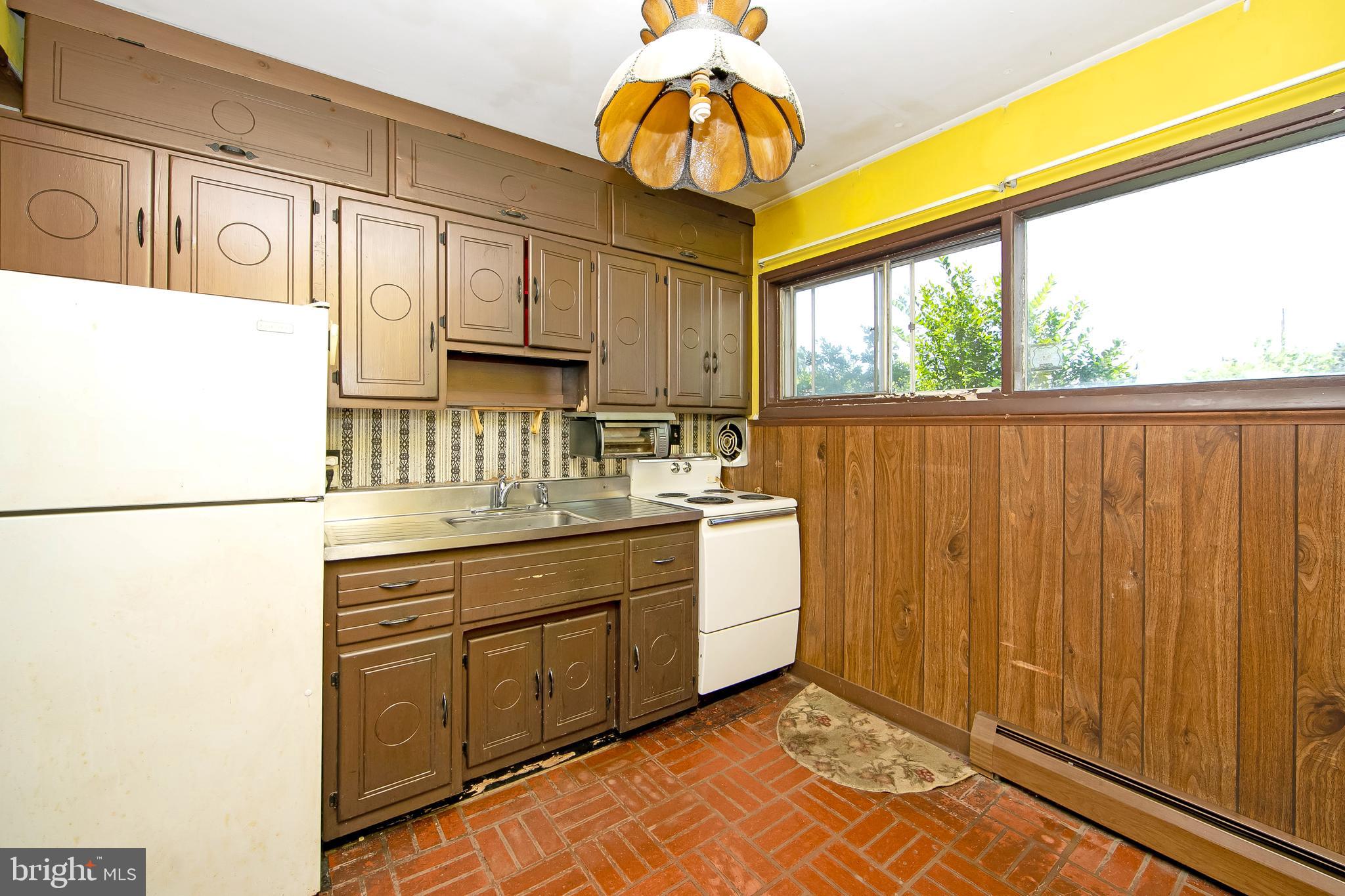 12 Geranium Road Levittown, PA 19057 - Photo 6 of 38 a kitchen with sink cabinets and window