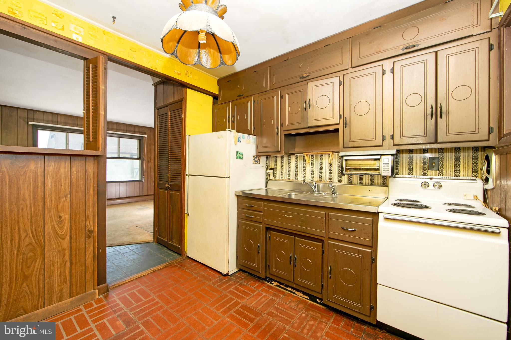 12 Geranium Road Levittown, PA 19057 - Photo 7 of 38 a kitchen with a refrigerator and a sink