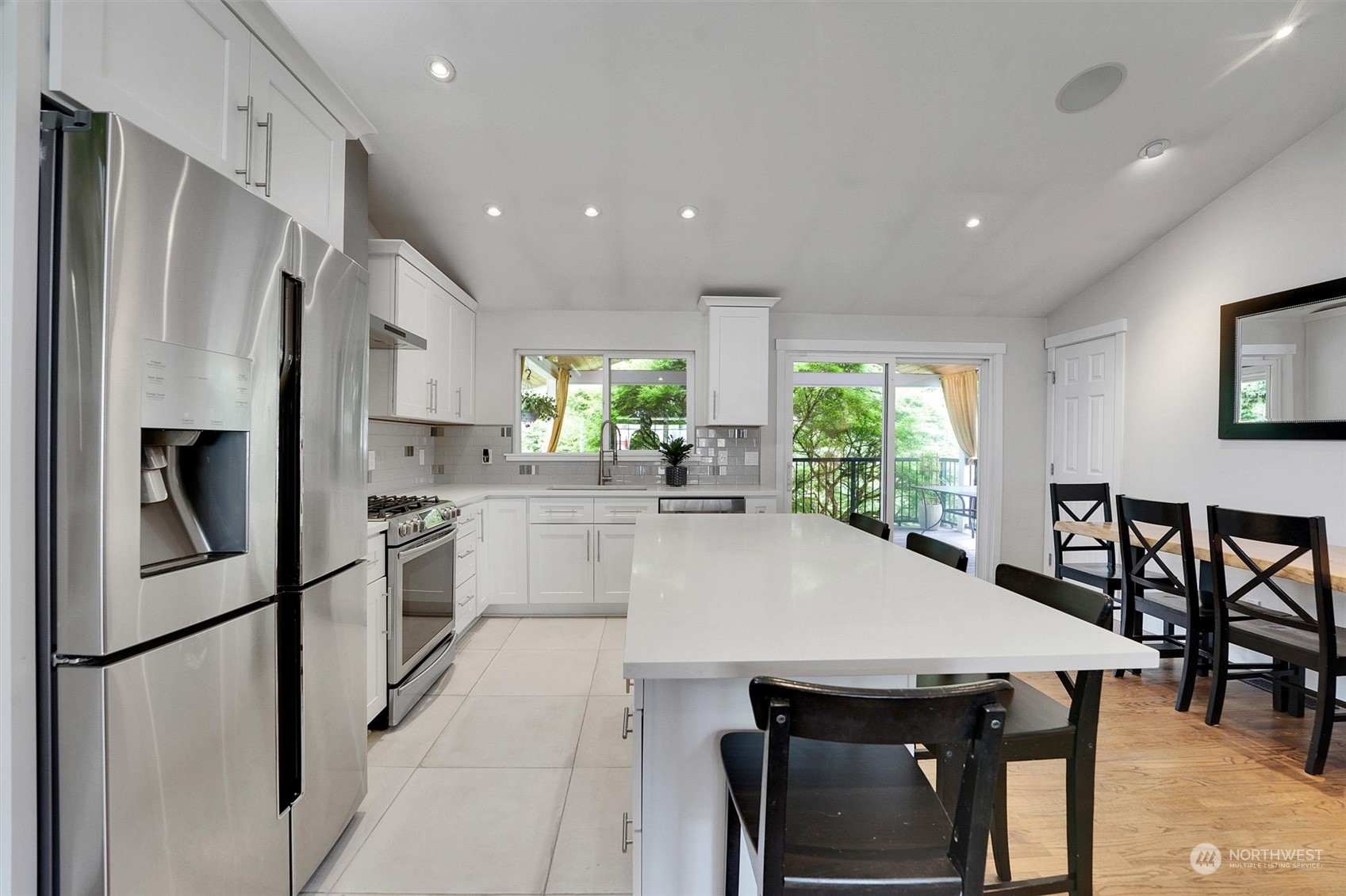 12451 169th Avenue Southeast Renton, WA 98059 - Photo 12 of 40 a kitchen with stainless steel appliances a refrigerator and a table