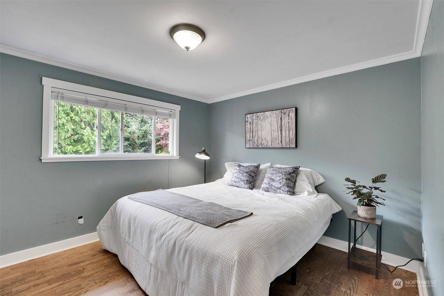 12451 169th Avenue Southeast Renton, WA 98059 - Photo 16 of 40 a bedroom with a large bed and a potted plant