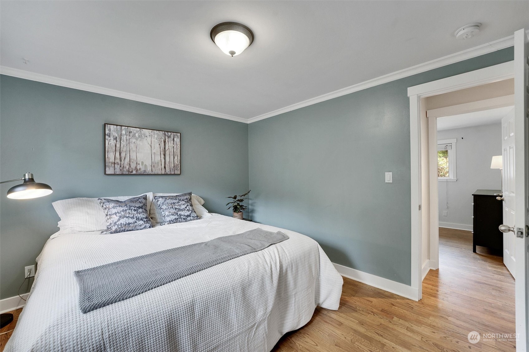 12451 169th Avenue Southeast Renton, WA 98059 - Photo 17 of 40 a bedroom with a large bed and a chandelier