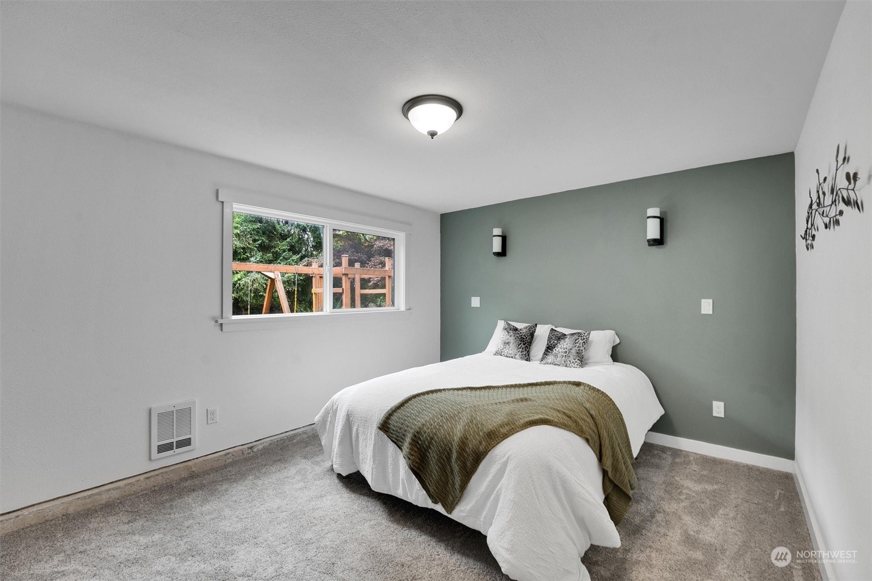 12451 169th Avenue Southeast Renton, WA 98059 - Photo 24 of 40 a bed sitting in a bedroom next to a window