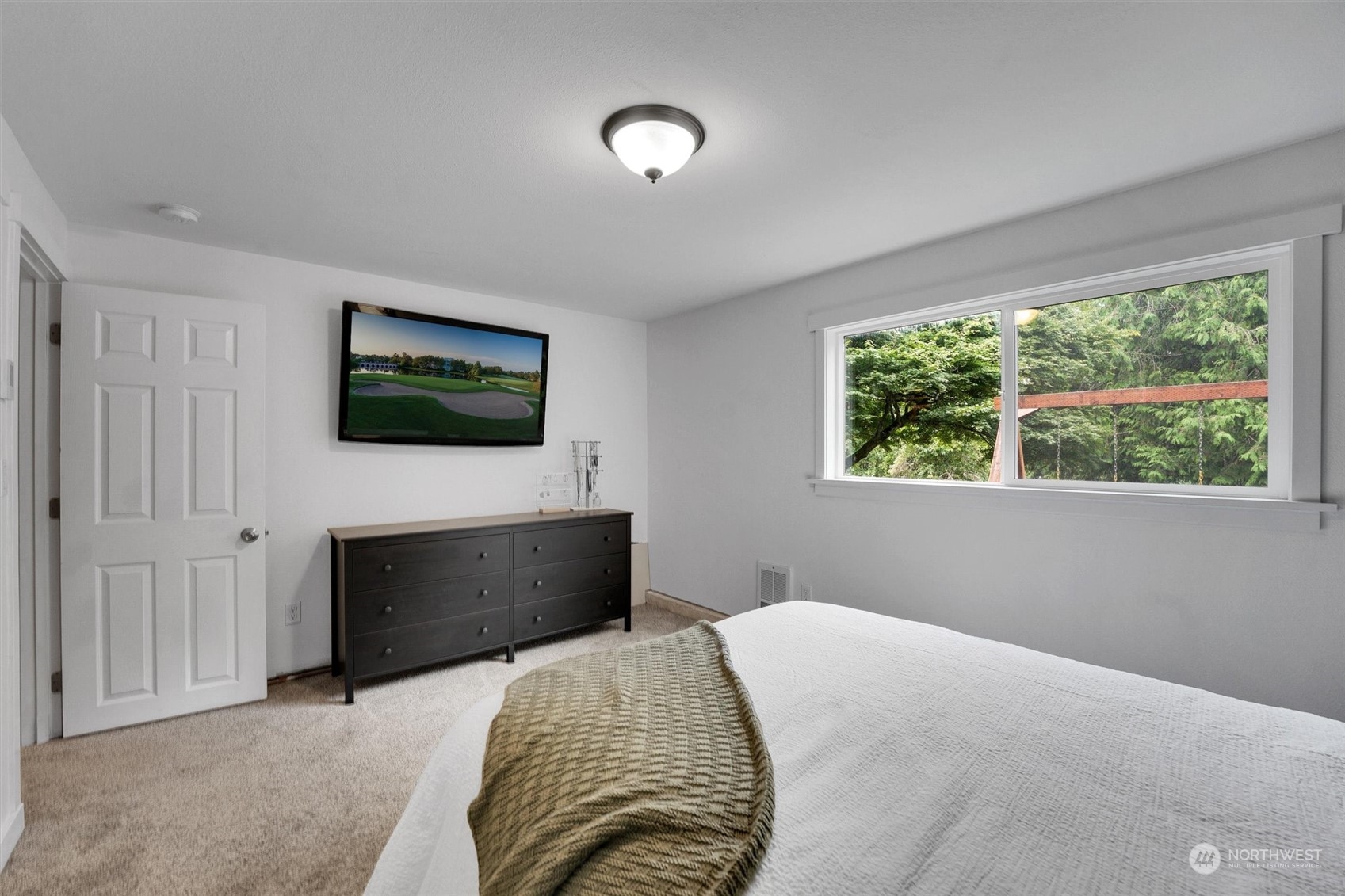12451 169th Avenue Southeast Renton, WA 98059 - Photo 26 of 40 a bedroom with a bed and a flat screen tv
