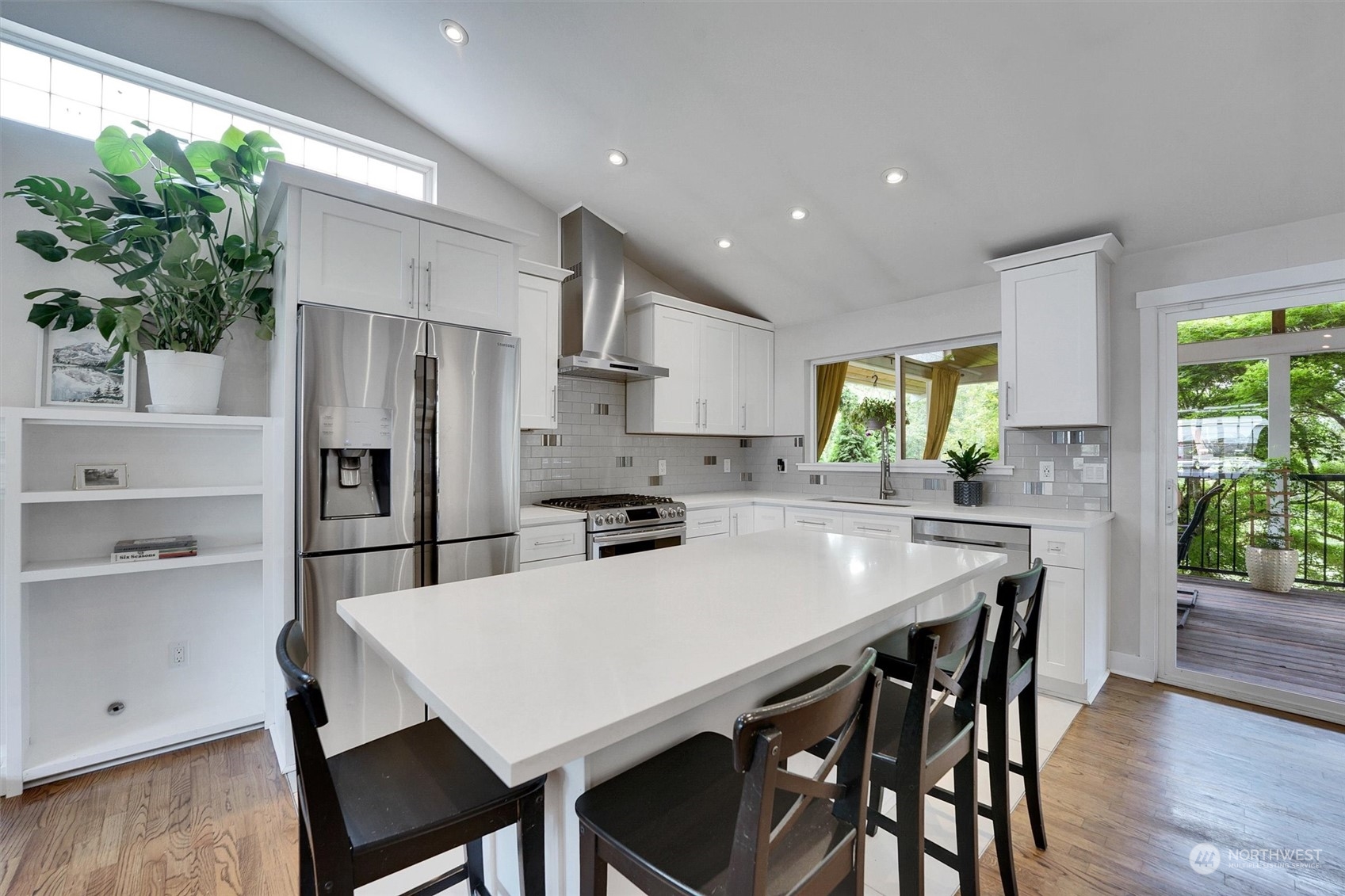 12451 169th Avenue Southeast Renton, WA 98059 - Photo 10 of 40 a kitchen with stainless steel appliances a table chairs and a refrigerator