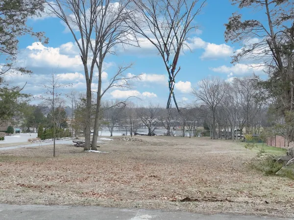 a view of dirt yard with a fountain
