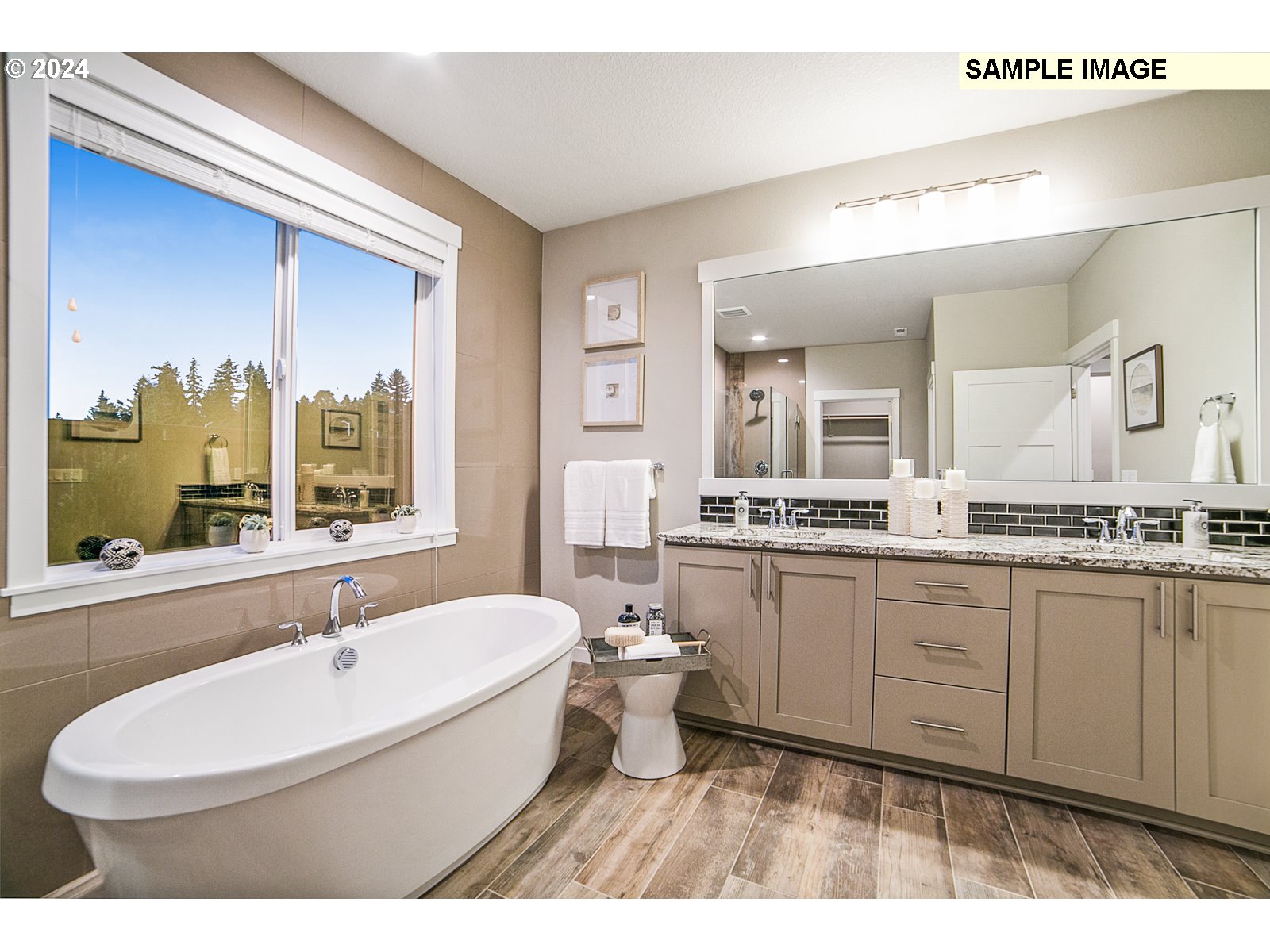 1344 North Kalani Loop, Unit LOT 65 Ridgefield, WA 98642 - Photo 11 of 24 a bathroom with a double vanity sink a mirror and a bathtub