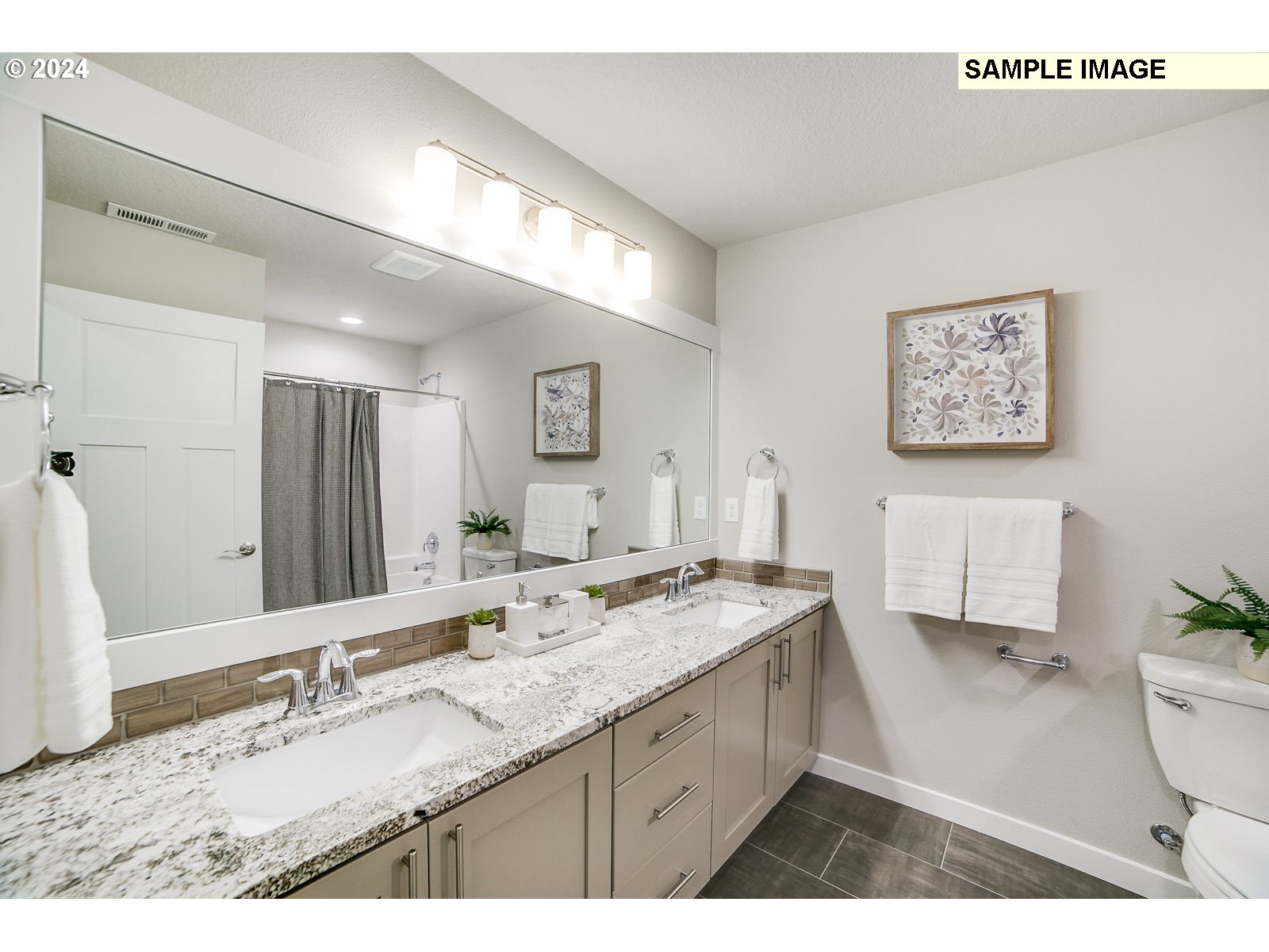 1344 North Kalani Loop, Unit LOT 65 Ridgefield, WA 98642 - Photo 15 of 24 a bathroom with a granite countertop sink mirror vanity and toilet