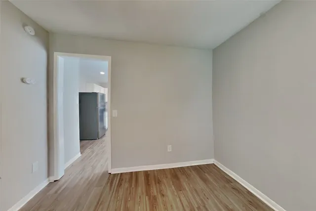 a view of a room with wooden floor
