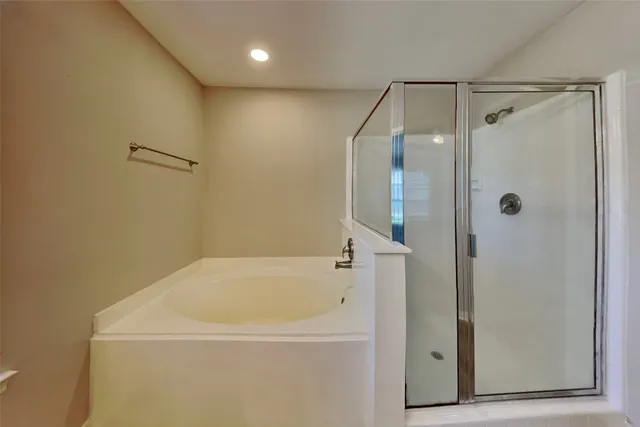 a bathroom with a bathtub and a shower