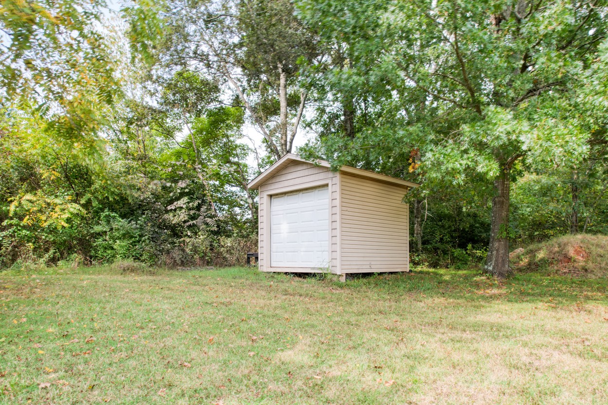1775 Beckwith Road Mount Juliet, TN 37122 - Photo 17 of 64 a backyard of a house with plants and large trees