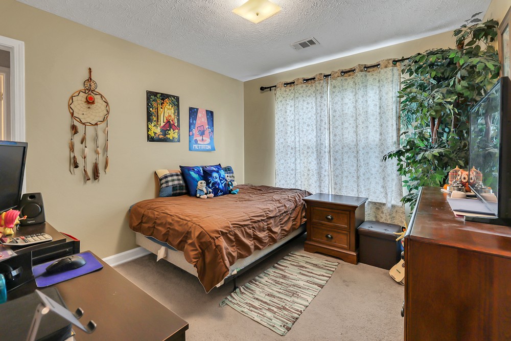 1775 Beckwith Road Mount Juliet, TN 37122 - Photo 59 of 64 a bedroom with a bed and a couch