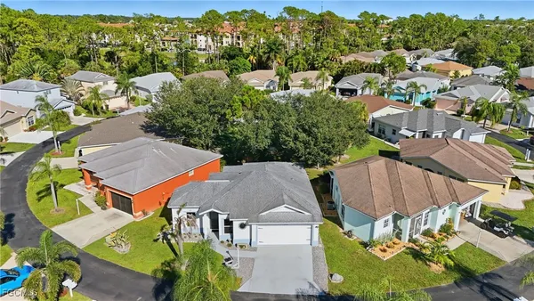 an aerial view of multiple houses with yard