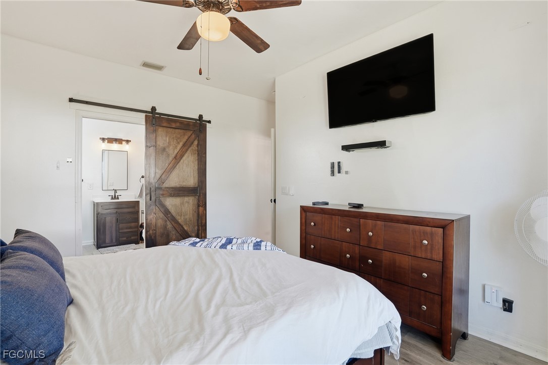 10733 Rio Mar Circle Estero, FL 33928 - Photo 17 of 40 a bedroom with a bed and a flat tv screen on dresser