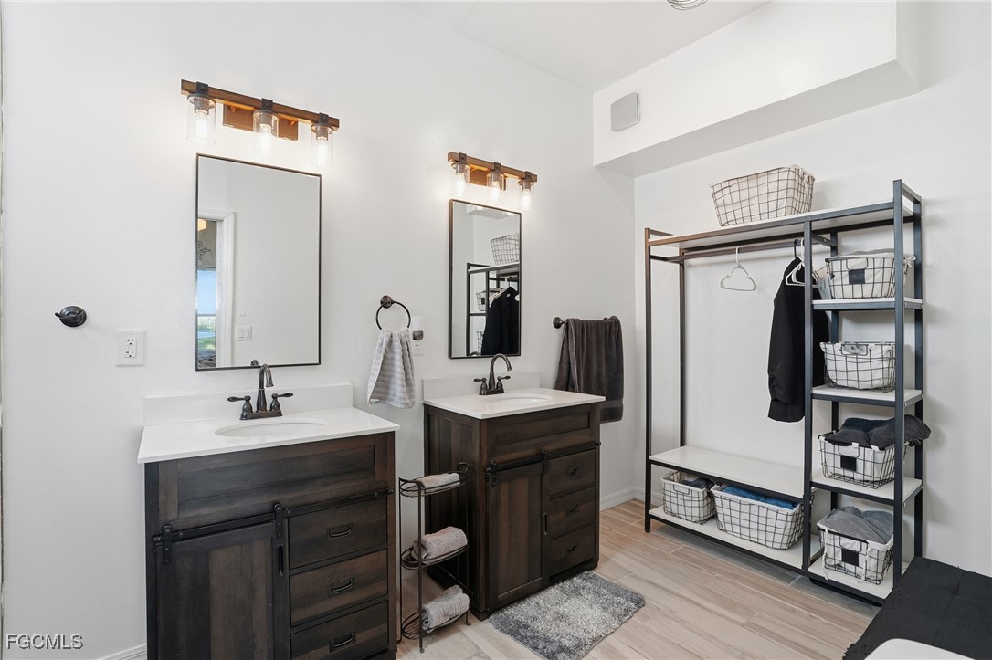 10733 Rio Mar Circle Estero, FL 33928 - Photo 19 of 40 a bathroom with a sink and mirror