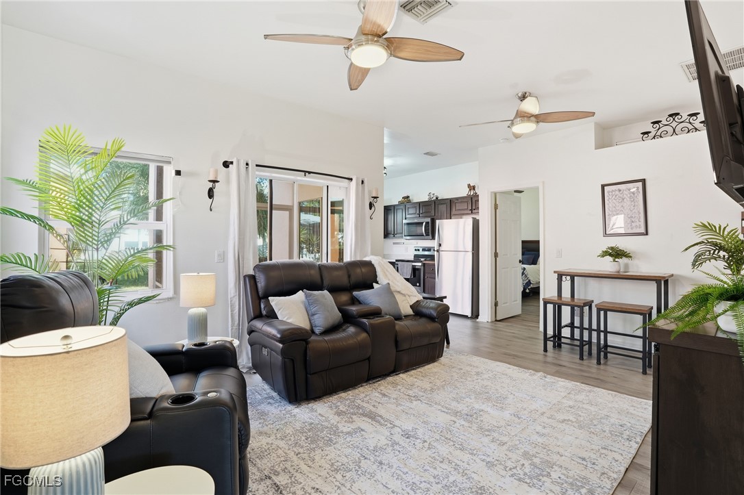 10733 Rio Mar Circle Estero, FL 33928 - Photo 2 of 40 a living room with furniture dining area and a chandelier