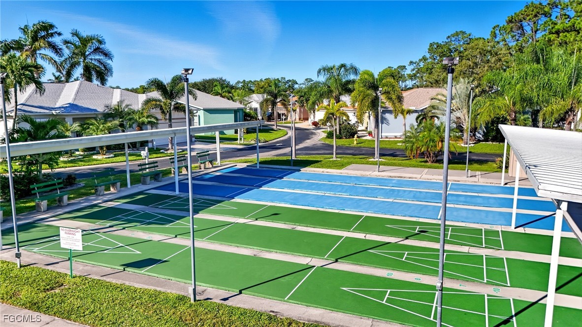10733 Rio Mar Circle Estero, FL 33928 - Photo 29 of 40 a view of a tennis ground with large trees