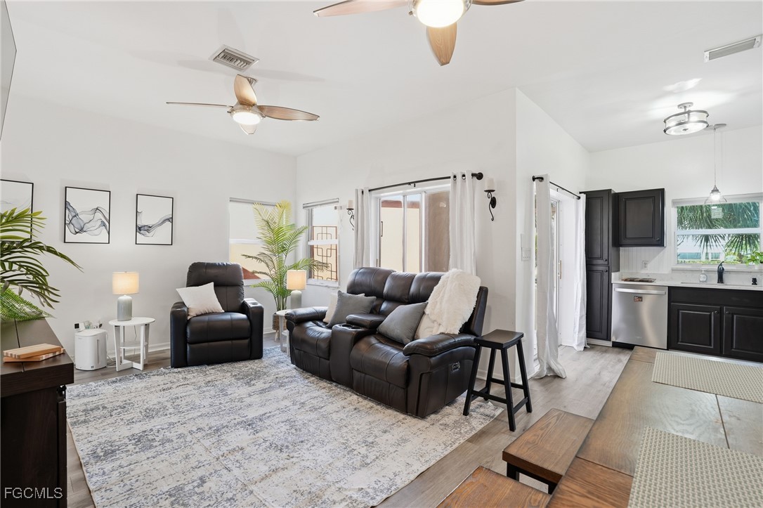 10733 Rio Mar Circle Estero, FL 33928 - Photo 3 of 40 a living room with furniture and a chandelier