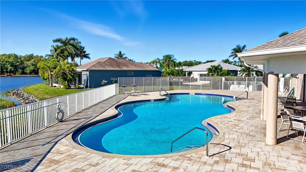 10733 Rio Mar Circle Estero, FL 33928 - Photo 31 of 40 a view of a swimming pool with a lounge chairs