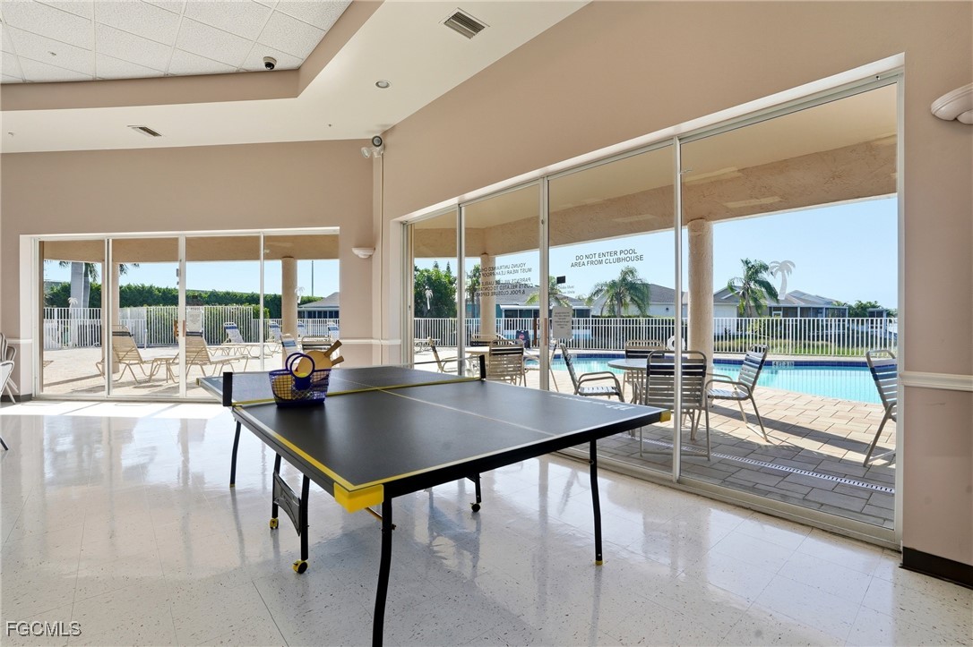 10733 Rio Mar Circle Estero, FL 33928 - Photo 35 of 40 a dining room with glass top table and chairs