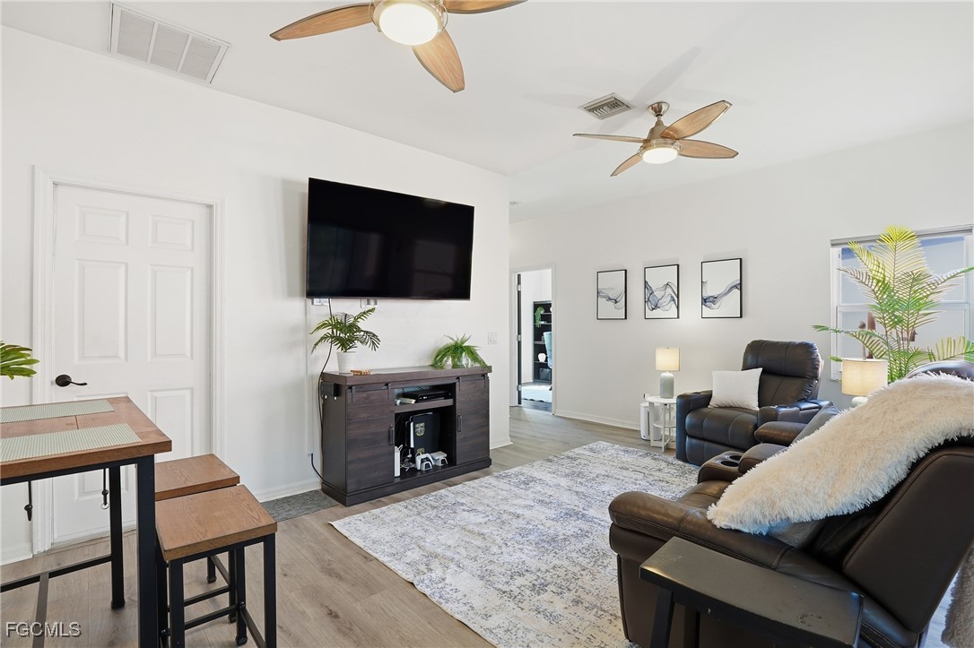 10733 Rio Mar Circle Estero, FL 33928 - Photo 4 of 40 a living room with furniture and a flat screen tv