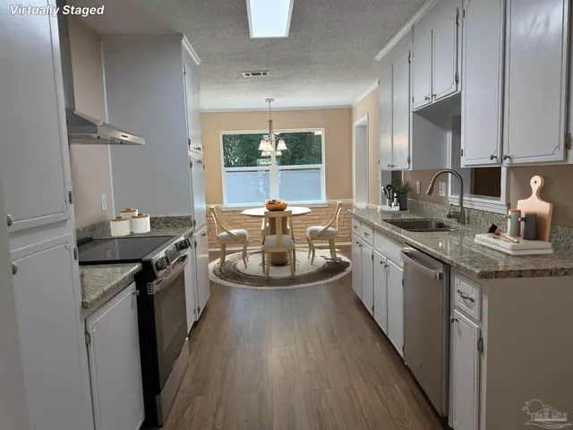 a kitchen with sink a counter top space and appliances
