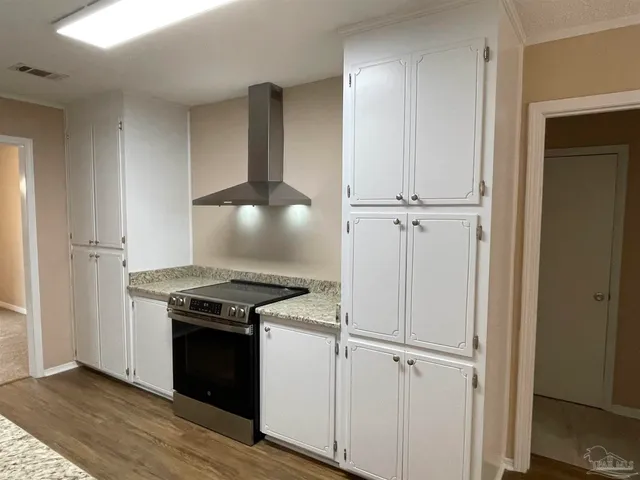 a kitchen with a stove and a refrigerator