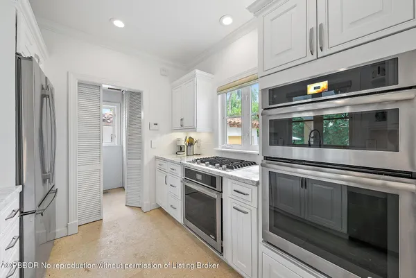 a kitchen with stainless steel appliances granite countertop a stove and a microwave