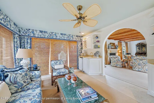 a living room with furniture a fireplace and a chandelier
