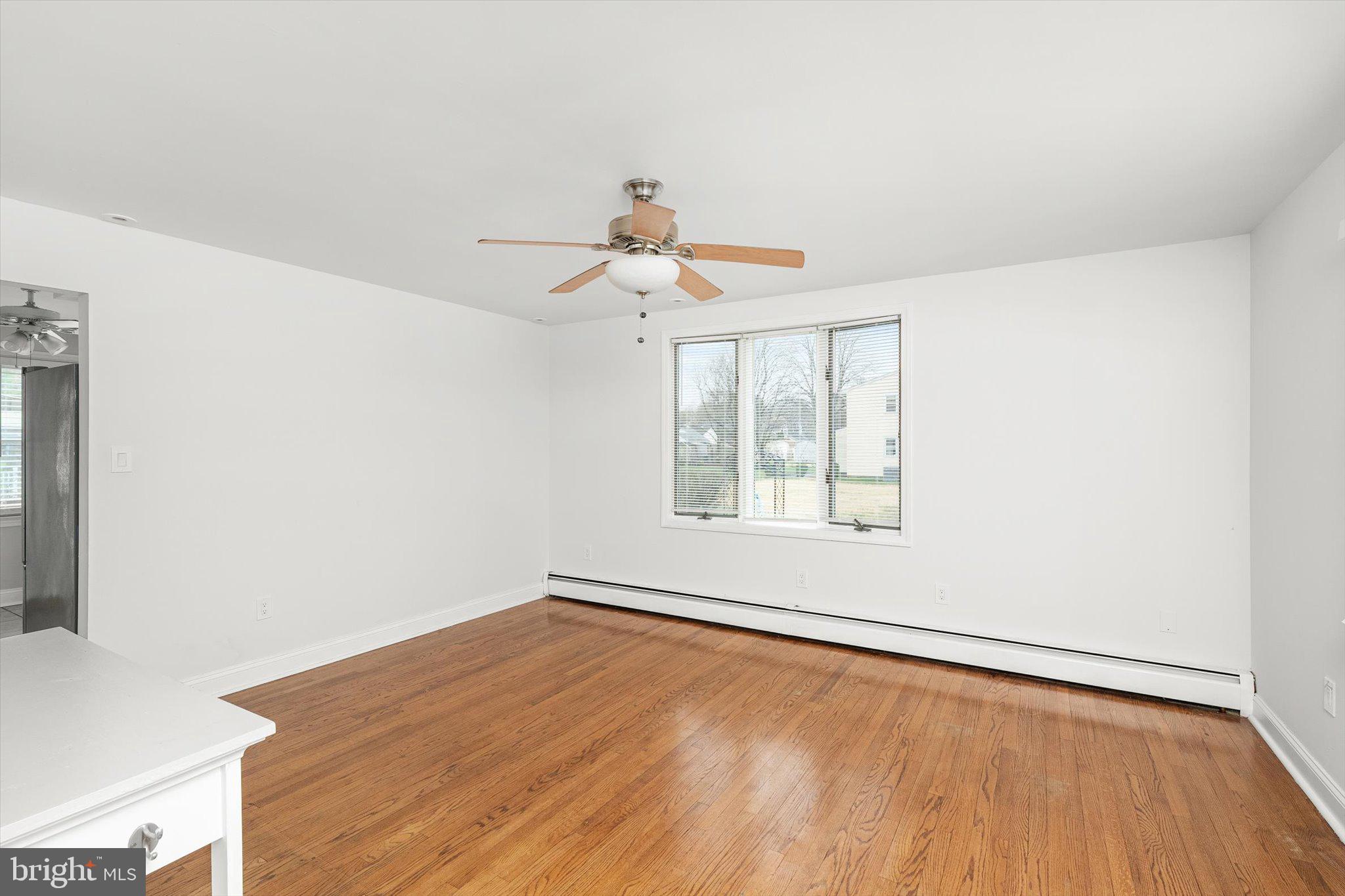 446 Trinity Avenue Hamilton, NJ 08619 - Photo 12 of 31 a view of an empty room with wooden floor and a window